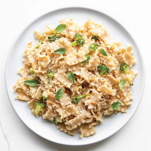 Jovial Gluten Free Brown Rice Mafalda pasta in a bowl, showcasing the light, yellowish pasta strands made from brown rice.