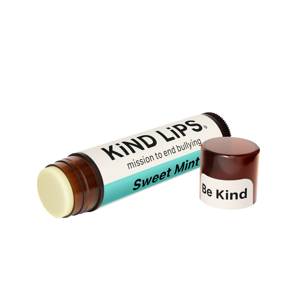 Kind Lips Sweet Mint Organic Lip Balm in a small container with mint-flavored lip balm visible inside.