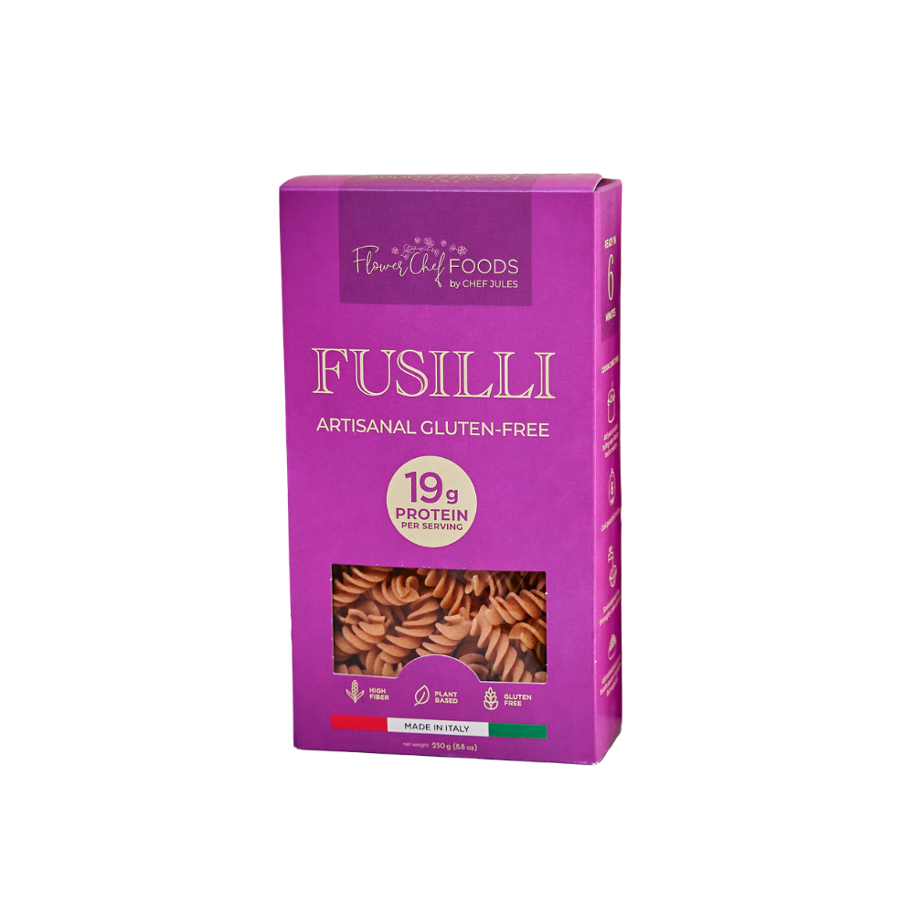Flower Chef Foods high protein fusilli pasta in a clear bowl, showcasing the spiral-shaped pasta ready for cooking.