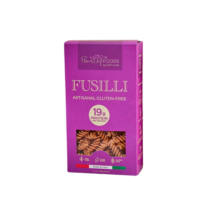 Flower Chef Foods high protein fusilli pasta in a clear bowl, showcasing the spiral-shaped pasta ready for cooking.