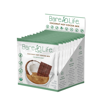 Bare Life dairy-free coconut hot cocoa mix single serving packets, showing the packaging and cocoa mix inside.