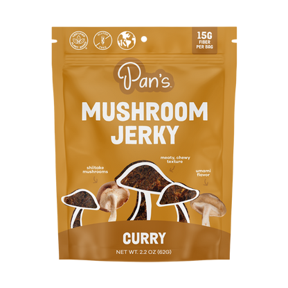 Pan's Mushroom Jerky Curry Mushroom Jerky close-up showing dried mushroom slices with curry seasoning on a white background.