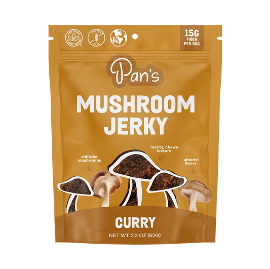 Pan's Mushroom Jerky Curry Mushroom Jerky close-up showing dried mushroom slices with curry seasoning on a white background.