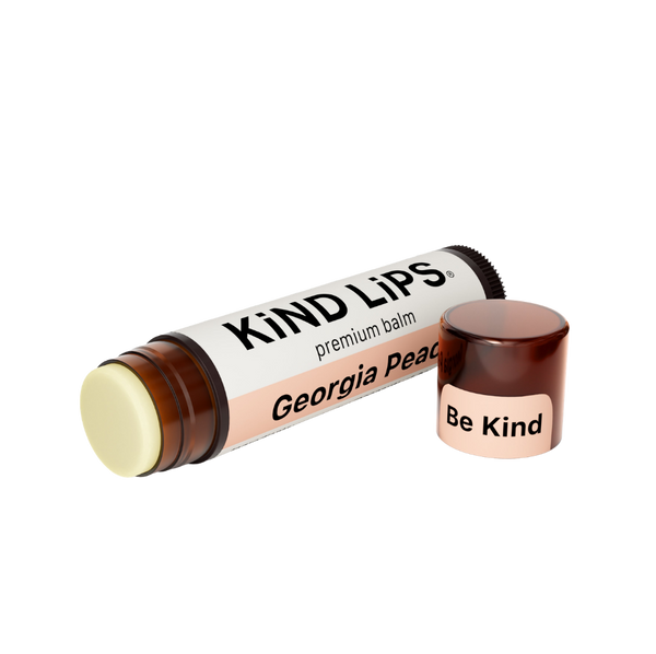 Kind Lips Georgia Peach organic lip balm tube with peach-colored packaging and brand logo, designed for nourishing lip care.