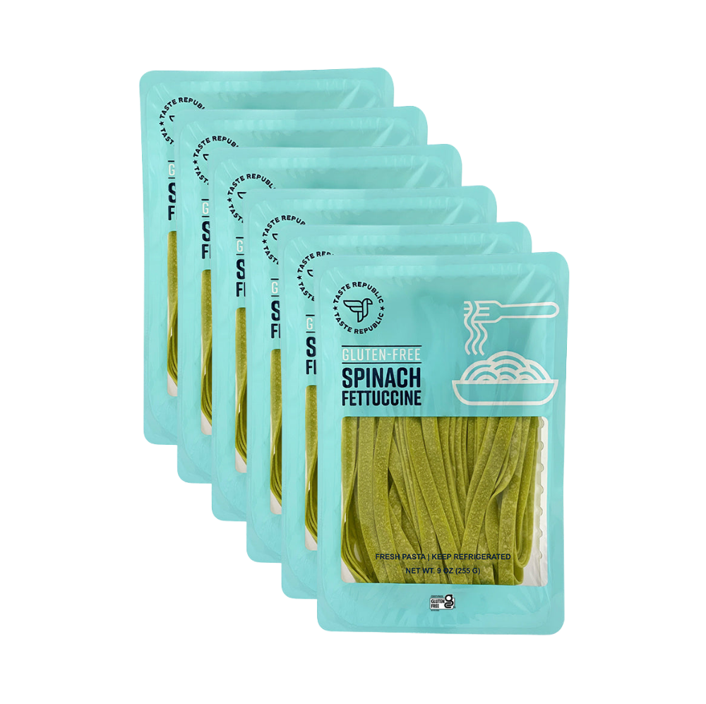 Taste Republic gluten-free spinach fettuccine pasta in a 6-pack, showing the fresh green pasta strips on a white background.