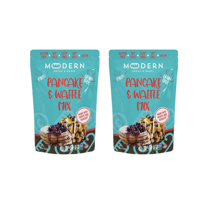 Modern Bread & Bagel pancake and waffle mix package with images of prepared pancakes and waffles on a wooden table.