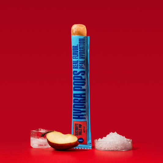 Hydra Pops Apple flavored hydration supplement in a clear plastic tube with colorful branding and a bright apple design.