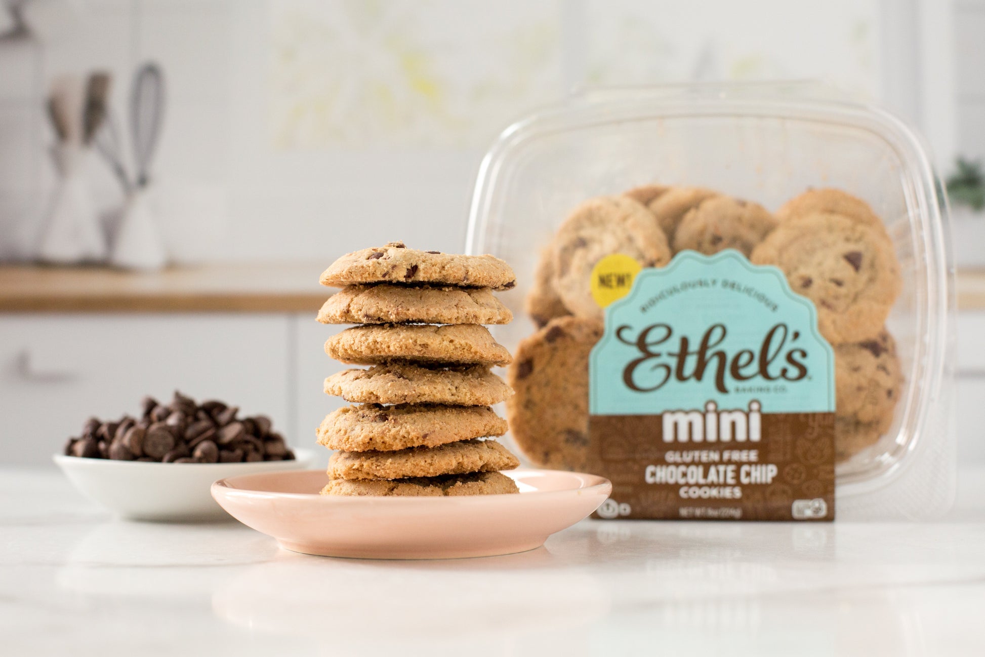 Two mini chocolate chip cookies from Ethel's Baking Company on a white plate, showcasing golden-brown edges and chocolate chips.