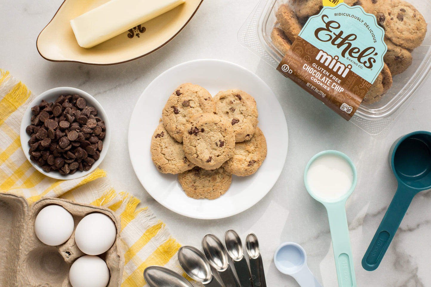 Two mini chocolate chip cookies from Ethel's Baking Company on a white plate, showcasing golden-brown cookies with chocolate chips.