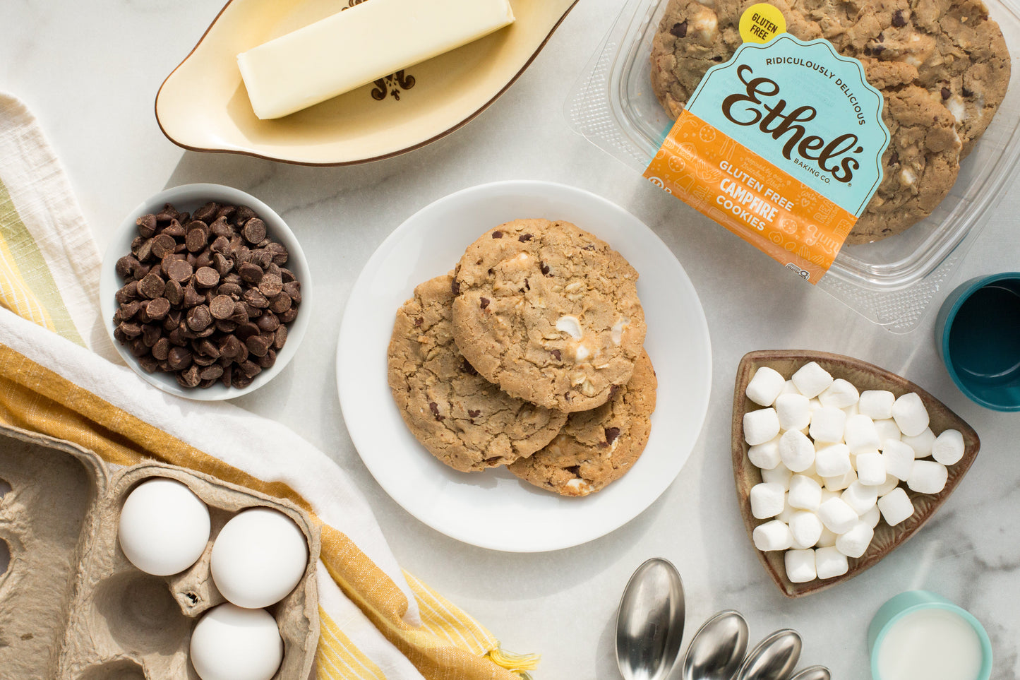 Two Ethel's Campfire Cookies from Ethels Baking Company, soft cookies with chocolate and marshmallow flavors, on a rustic plate.