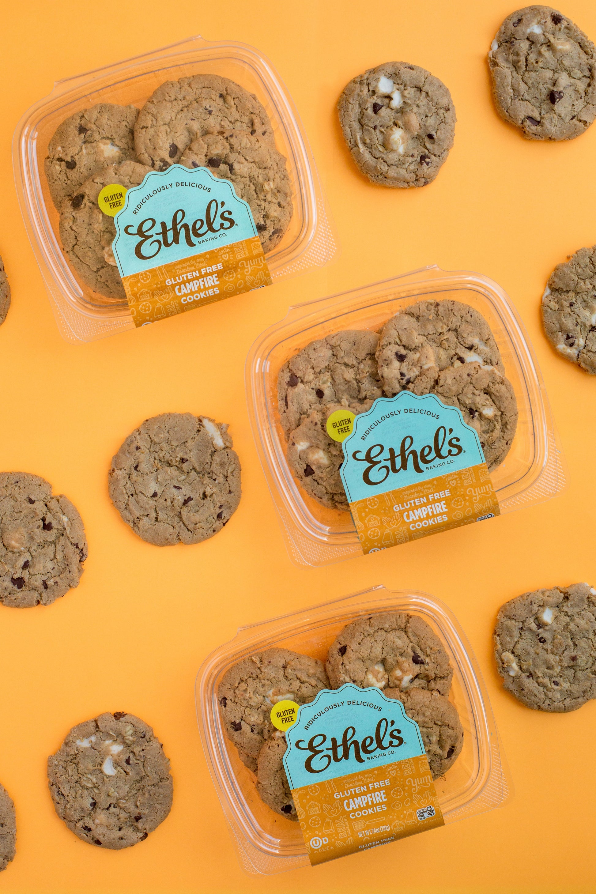 Two Ethel's Campfire Cookies from Ethels Baking Company placed on a rustic wooden surface, showcasing their golden-brown, baked appearance.