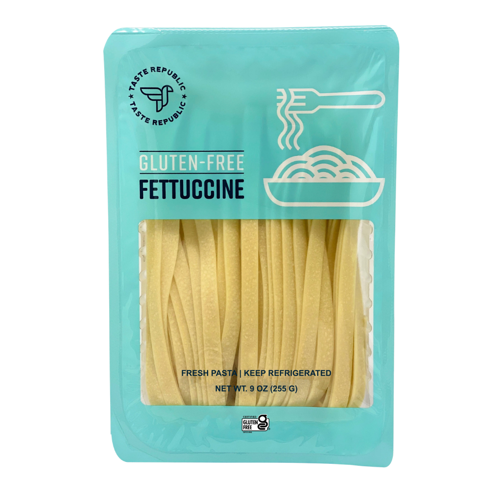 Taste Republic gluten-free fettuccine pasta pack with six servings, showcasing fresh, uncooked pasta strands in a clear container.