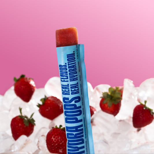 Hydra Pops Strawberry flavored hydration ice pops by Hydra Hydration, showing two chilled strawberry ice pops with vibrant red color
