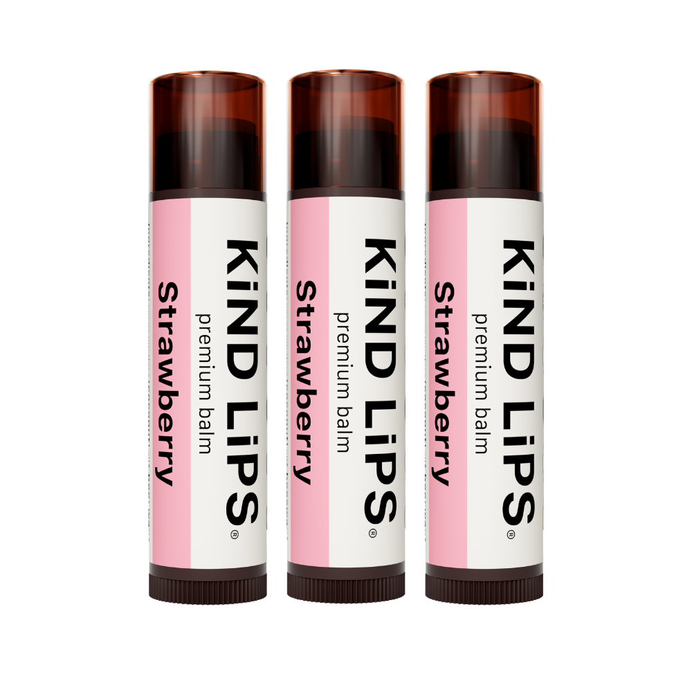 Organic strawberry lip balm by Kind Lips, showing a natural tube with pink packaging and a fresh strawberry flavor label.