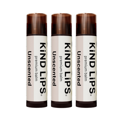 Kind Lips Unscented Organic Lip Balm in a small container with a white lid, displayed on a neutral background.
