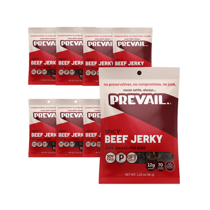 Package of PREVAIL Jerky Spicy Beef Jerky single-serve 8-pack with visible jerky pieces in clear packaging.