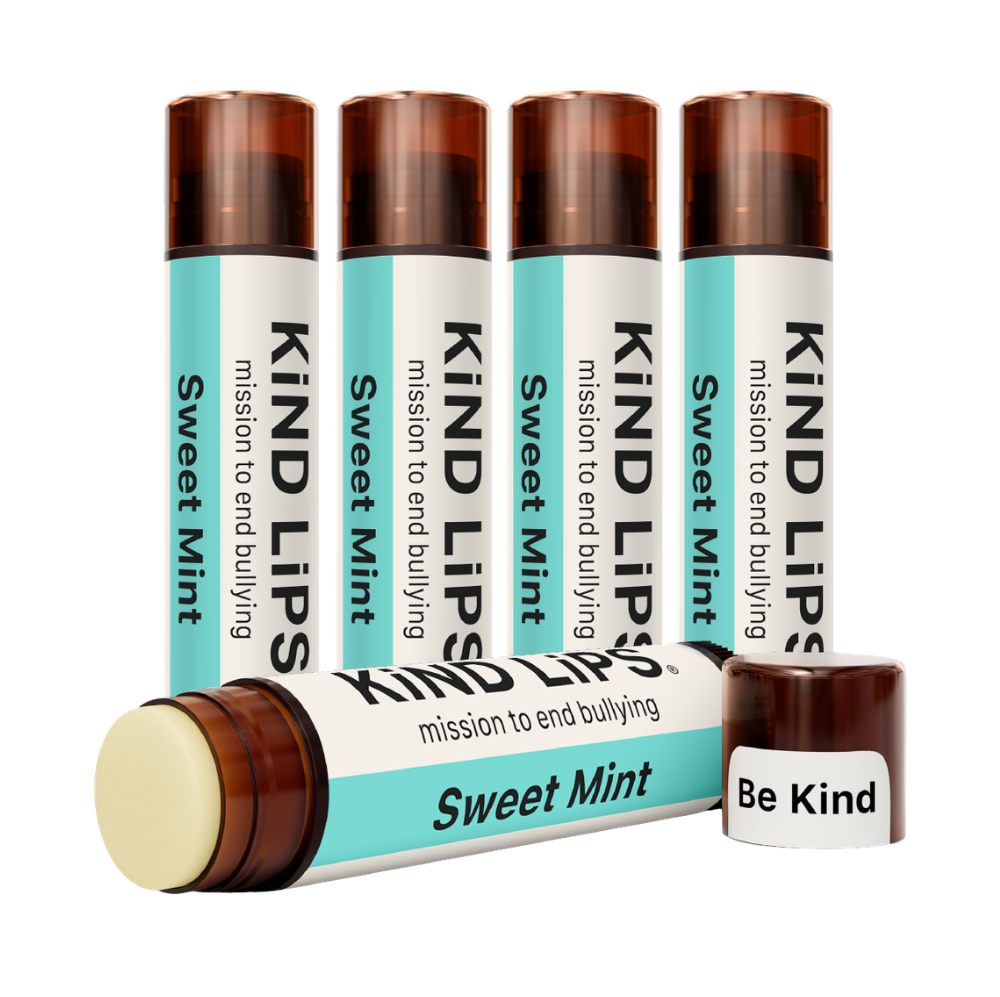 Kind Lips Sweet Mint Organic Lip Balm in a small tube with a clear label, featuring a mint illustration and natural packaging.