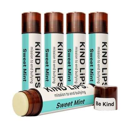 Kind Lips Sweet Mint Organic Lip Balm in a small tube with a clear label, featuring a mint illustration and natural packaging.