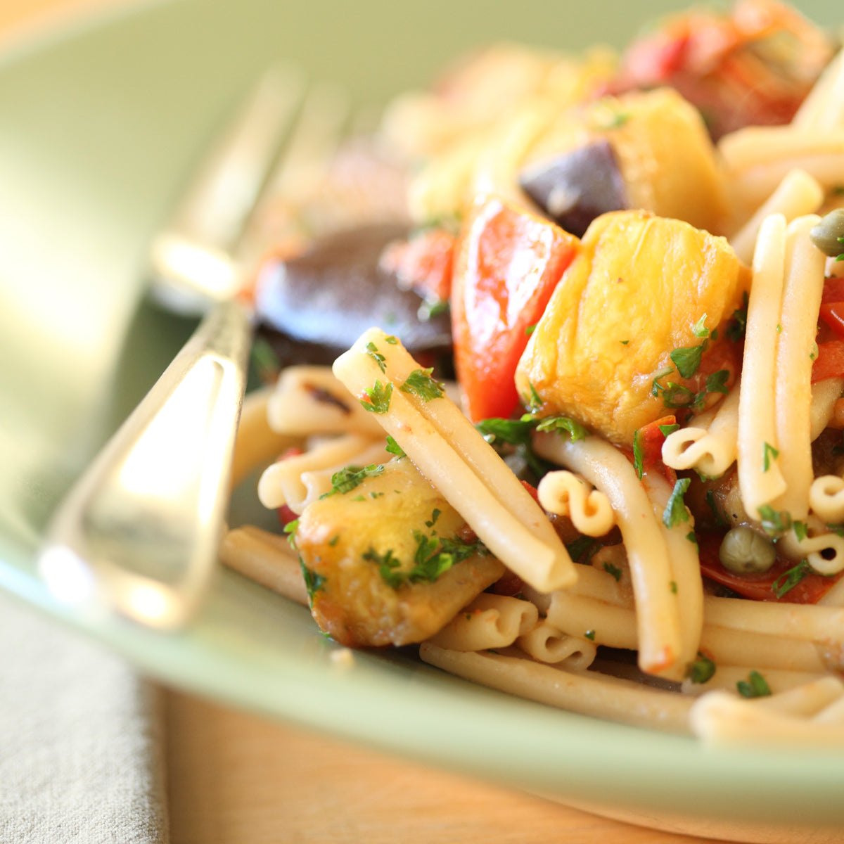 Jovial Gluten Free Brown Rice Caserecce pasta on a white plate, showcasing the short, twisted pasta shape made from brown rice.