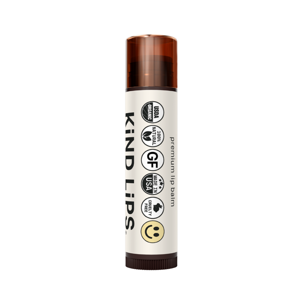 Four tubes of Kind Lips Organic Lip Balm in a variety pack, featuring colorful packaging and natural ingredients for soft, moisturized lips.
