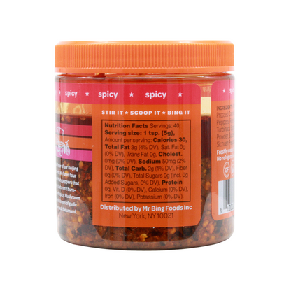 Two 7oz jars of Mr Bing Chili Crisp from Mr Bing Foods, showcasing the spicy chili paste with a textured surface.