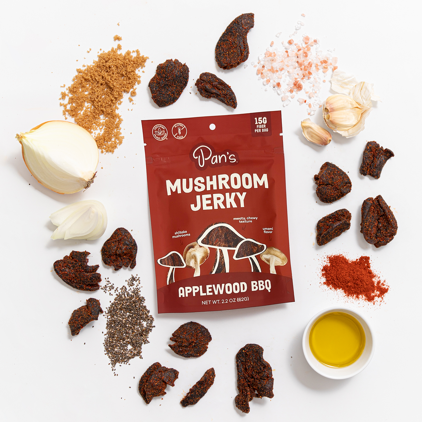 Pan's Mushroom Jerky Applewood BBQ Mushroom Jerky with smoky, savory flavor and tender texture, displayed on a wooden surface