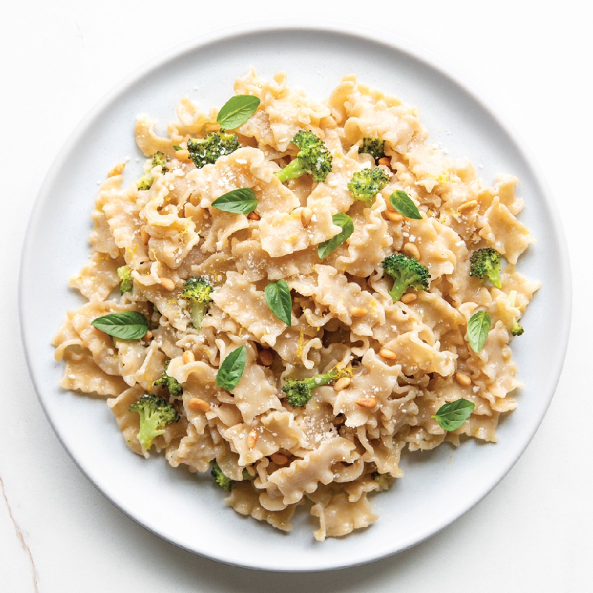 Jovial Gluten Free Brown Rice Mafalda pasta in a bowl, showcasing the light, yellowish pasta strands made from brown rice.