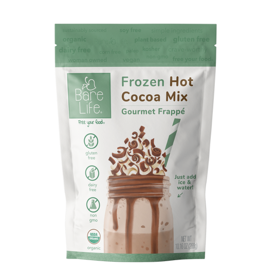 Bare Life dairy-free frozen hot cocoa mix in a glass, showing creamy, rich hot chocolate with a vegan, organic, gluten-free label.