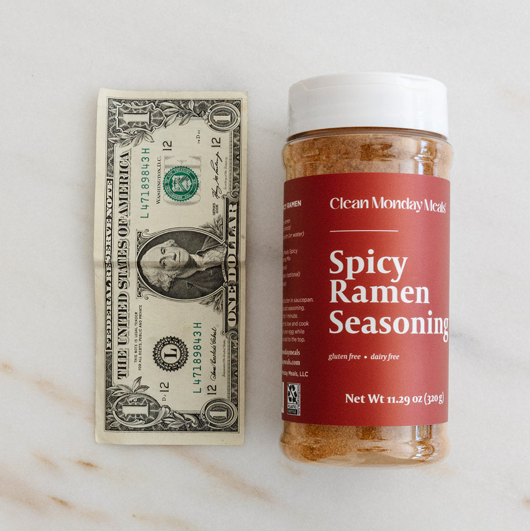 Spicy ramen seasoning packet from Clean Monday Meals with vibrant red and orange packaging and spicy flavor labels.