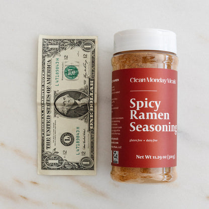 Spicy ramen seasoning packet from Clean Monday Meals with vibrant red and orange packaging and spicy flavor labels.