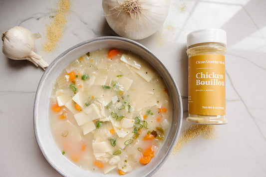 Clean Monday Meals chicken bouillon seasoning in a jar, with label visible, used for enhancing soups and stews.