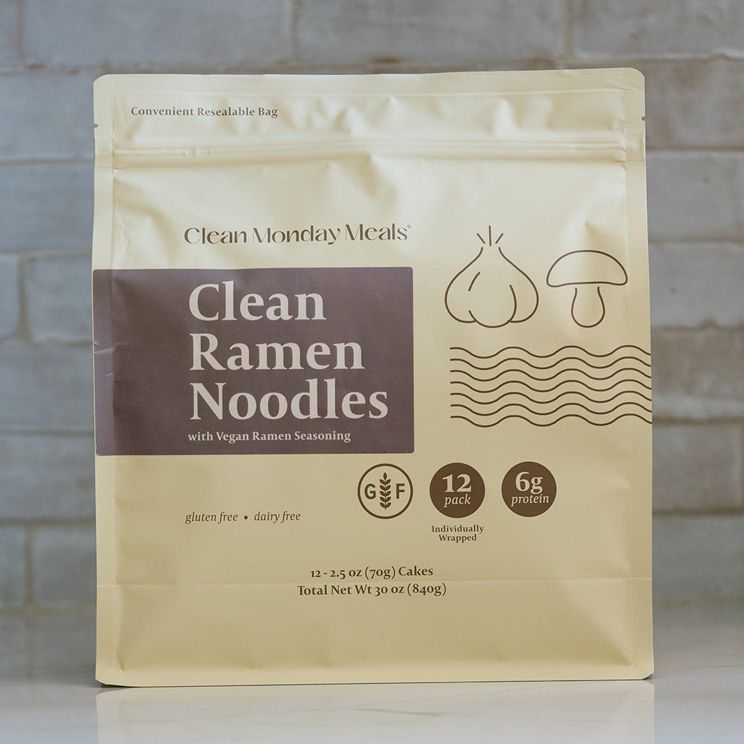 Clean Monday Meals Ramen Noodles in a bowl with broth, garnished with vegetables and green onions, ready to serve.