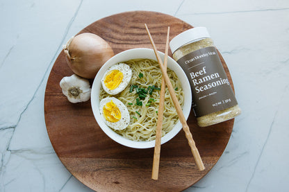 Close-up of Clean Monday Meals Beef Ramen Seasoning jar, showcasing the label and seasoning texture.