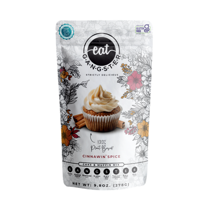 Eat G.A.N.G.S.T.E.R. Cinnawin™ Spice Cake and Muffin Mix in a box with a prepared cake and muffins on a plate.