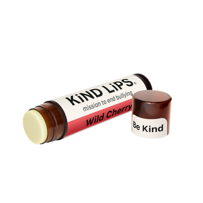 Kind Lips Wild Cherry Organic Lip Balm in a small tube, showcasing the natural product with cherry flavor and organic ingredients.