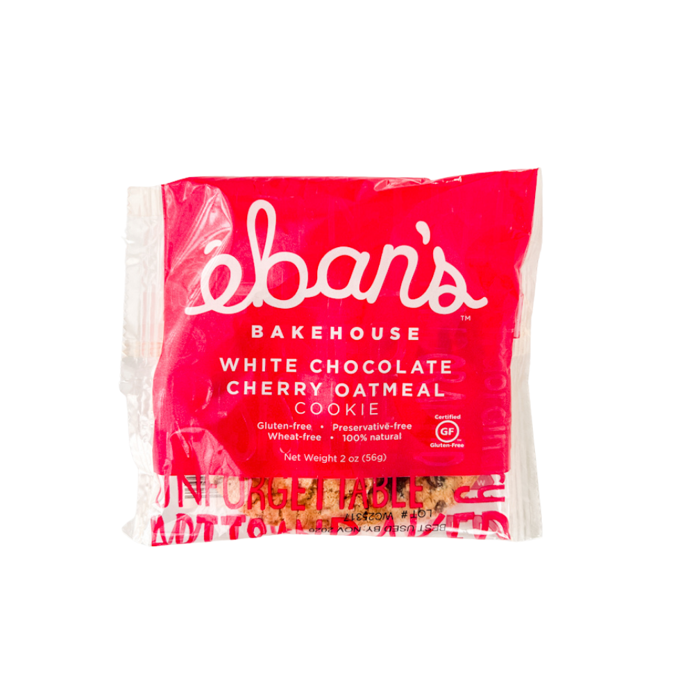 Eban’s Bakehouse white chocolate cherry oatmeal cookies in a 12-pack, showing golden cookies with white chocolate chunks and cherry pieces.