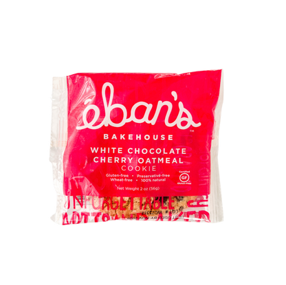 Eban’s Bakehouse white chocolate cherry oatmeal cookies in a 12-pack, showing golden cookies with white chocolate chunks and cherry pieces.