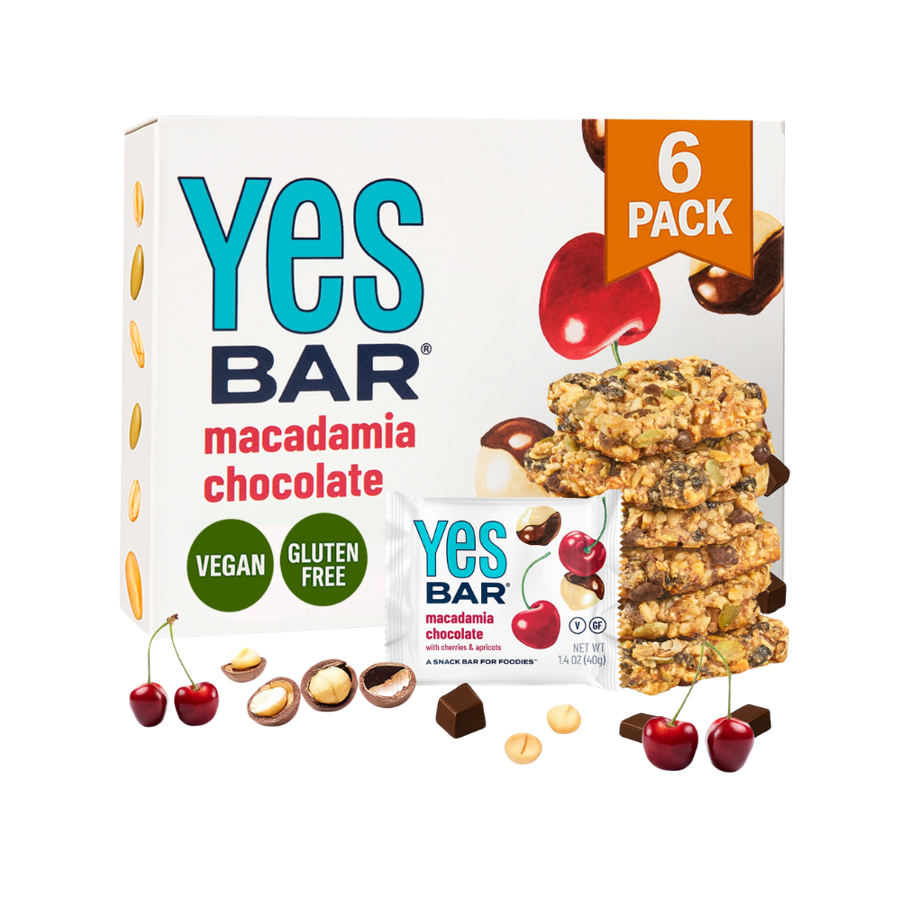 YES BAR Macadamia Chocolate energy bars, six-pack, showing chocolate-coated bars with macadamia nuts inside.