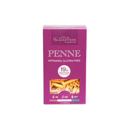 High protein Flower Chef Foods penne pasta in a clear bowl, showcasing the textured, uncooked pasta with a golden color.