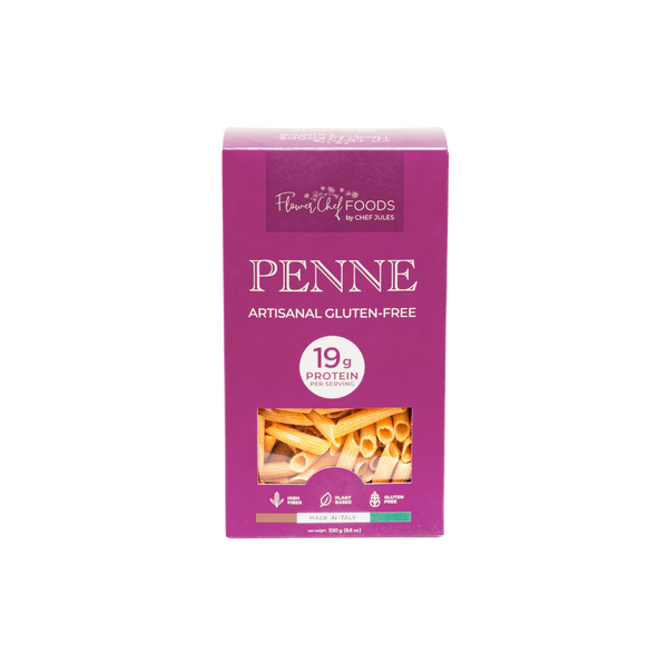 High protein Flower Chef Foods penne pasta in a clear bowl, showcasing the textured, uncooked pasta with a golden color.
