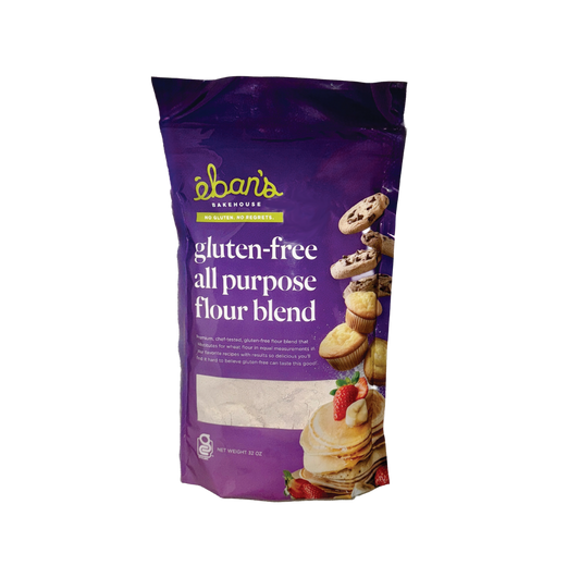 Eban’s Bakehouse gluten free all purpose flour blend in a 2lb bag, with a scoop of flour and baking ingredients on a wooden surface.