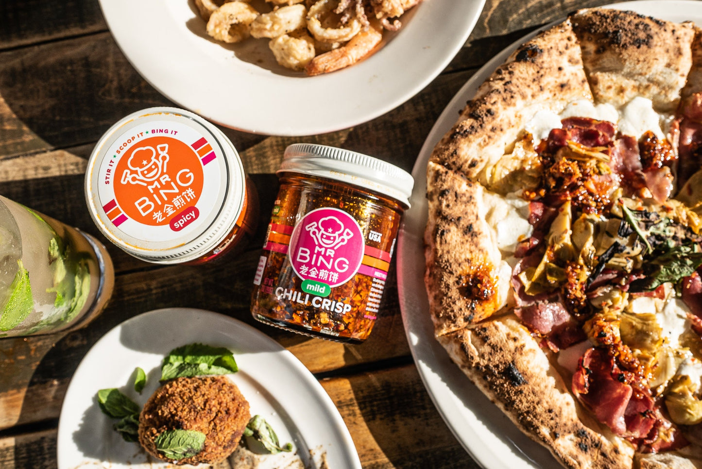 Two 7oz jars of Mr Bing Chili Crisp by Mr Bing Foods, showing the colorful labels and crisp glass jars.