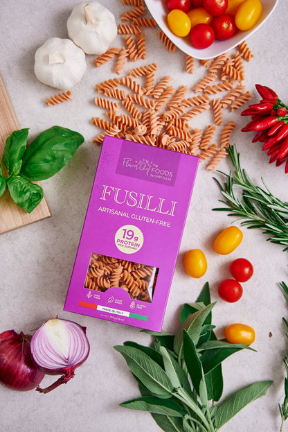 High protein Flower Chef Foods Fusilli pasta in a clear bowl, showcasing its spiral shape and vibrant color.