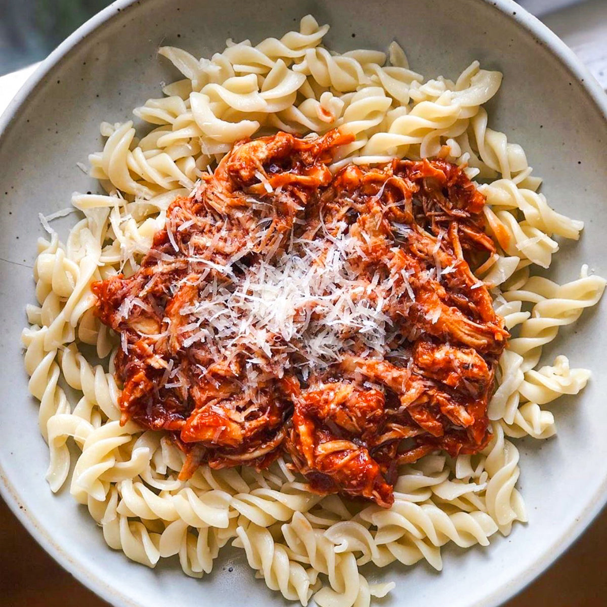 Fresh gluten-free fusilli pasta from Taste Republic Gluten-Free, shown in a 6-pack package on a wooden surface.