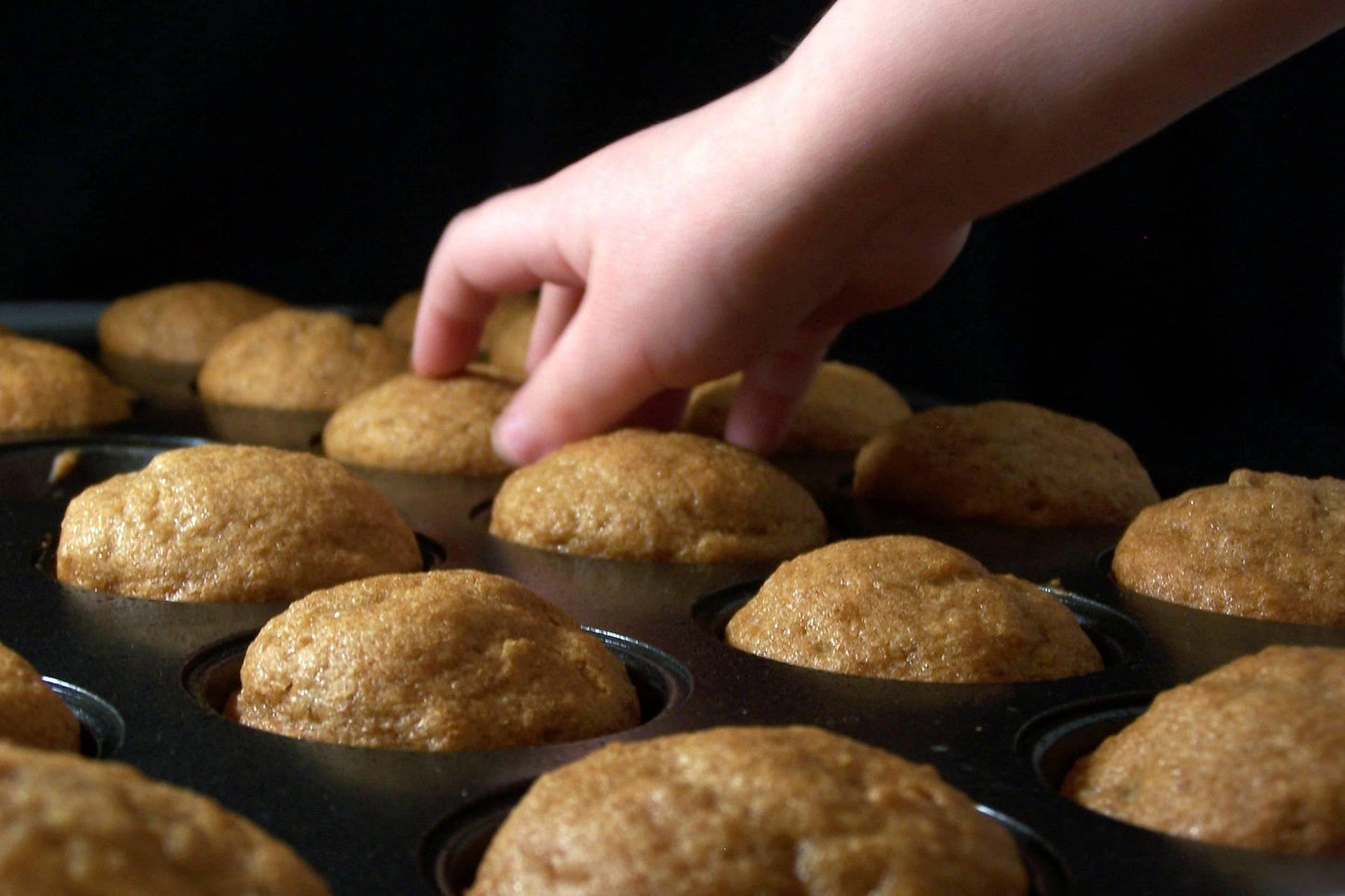 Gluten-free muffin mix by gfJules with a prepared muffin in a paper liner on a baking tray.