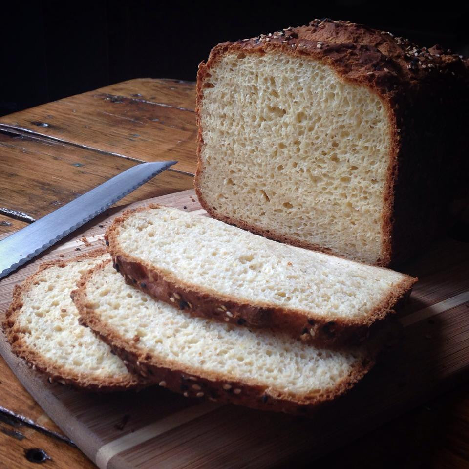 Gluten-free bread mix by gfJules, showing a packet of gfJules gluten free bread mix with ingredients in the background.