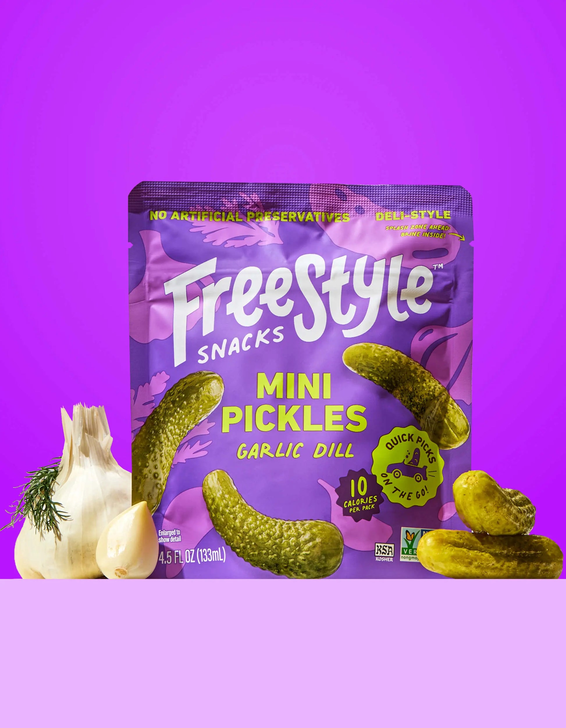 Jar of FreeStyle Snacks Garlic Dill Mini Pickles with fresh garlic and dill visible inside the transparent container.