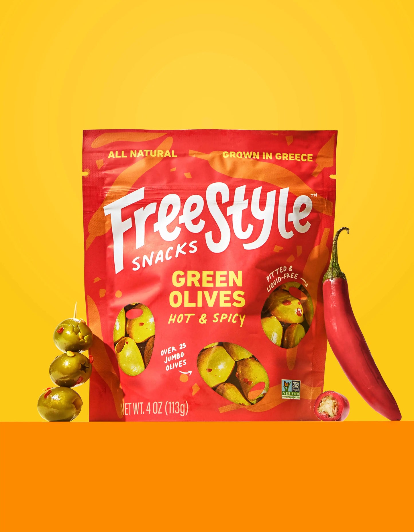 Spicy green olives by FreeStyle Snacks, showcasing a bowl of hot and spicy seasoned green olives on a white background.