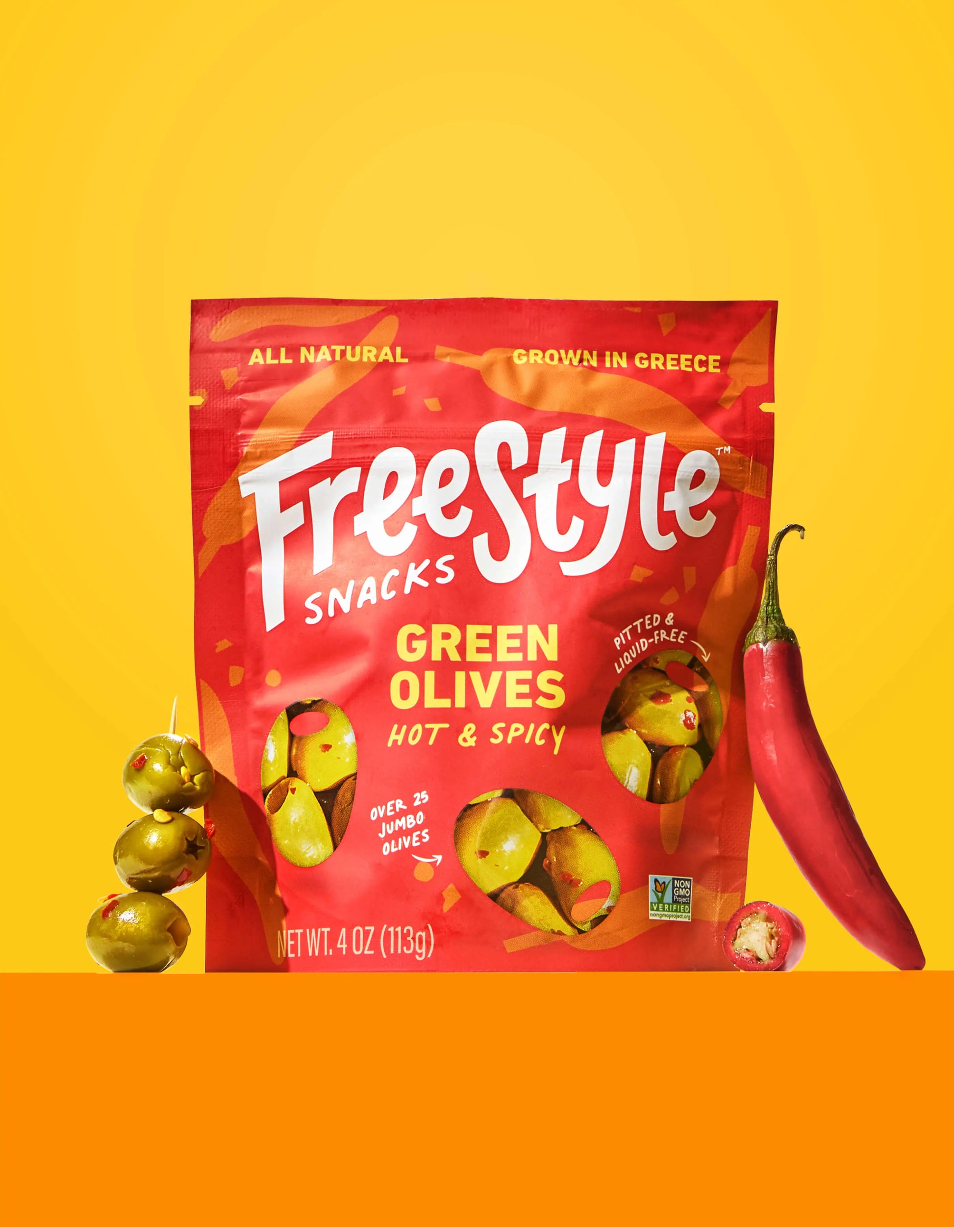 Spicy green olives by FreeStyle Snacks, showcasing a bowl of hot and spicy seasoned green olives on a white background.