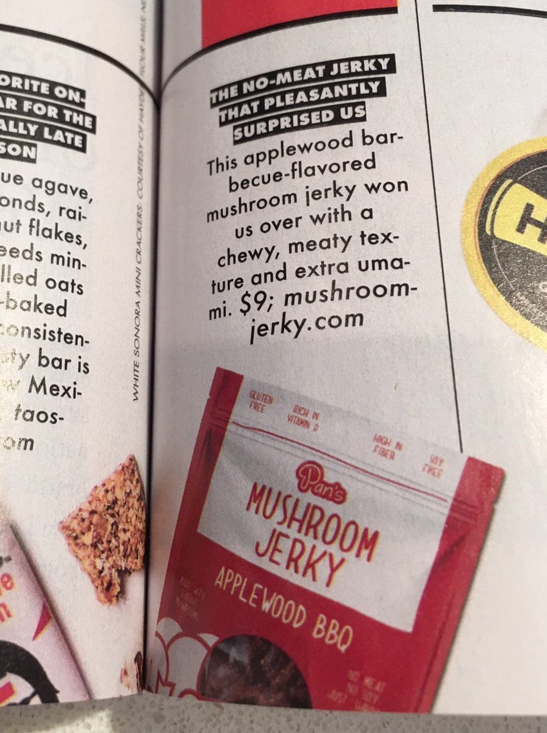 Pan's Mushroom Jerky Applewood BBQ Mushroom Jerky showing smokey glazed mushroom slices on a wooden surface.